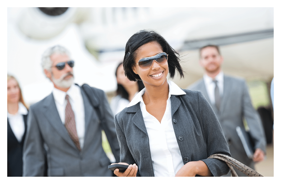 Diverse team of wealthy business executives deboarding private jet