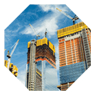 Skyscrapers construction site for modern buildings in New York. Cranes and scaffolding used to build tall structures, blue sky on background.