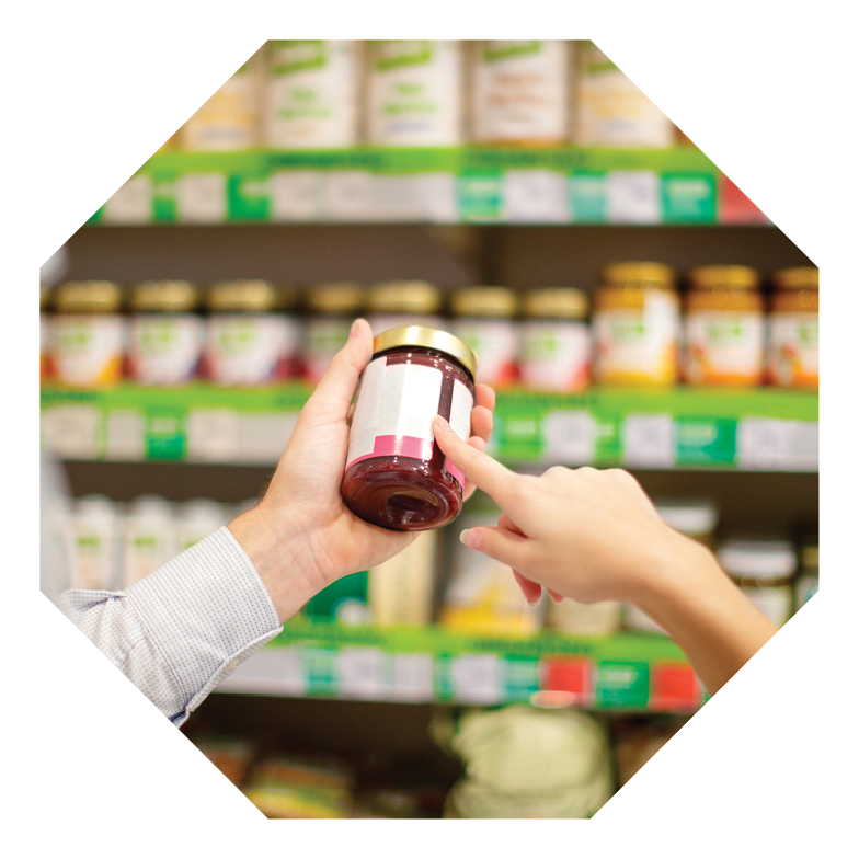 Couple choosing jar of marmalade, reading nutrition label