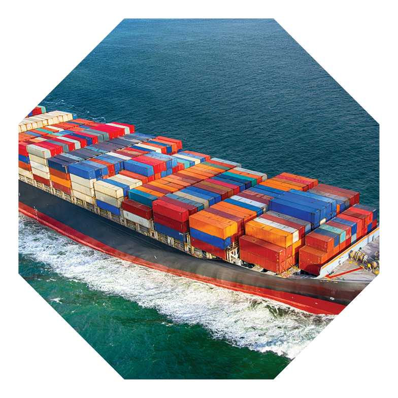 A fully stocked cargo ship heading out to sea.