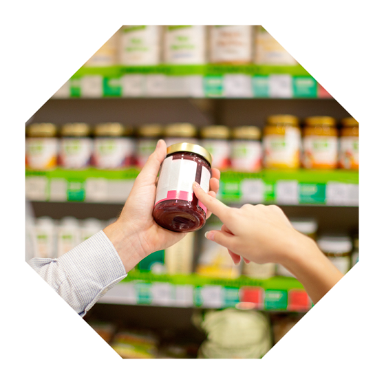 Couple choosing jar of marmalade, reading nutrition label