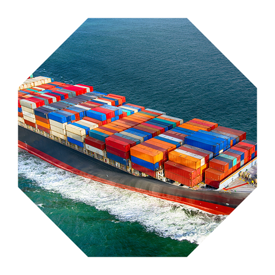 A fully stocked cargo ship heading out to sea.